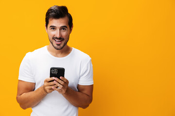 Man technology portrait smiling yellow space copy smartphone studio communication phone phone happy mobile cyberspace