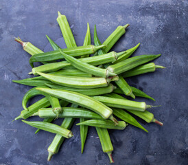 Fresh organic vegetables Lady's Finger or Okra on the Dark concrete floor