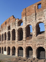 Fototapeta premium Detail of Colosseum or gladiator Arena famous stony ancient architecture. Arches of Flavian Amphitheatre. Construction of antique Roman Empire. Arena Flavio or Coliseum, iconic symbol of Imperial Rome