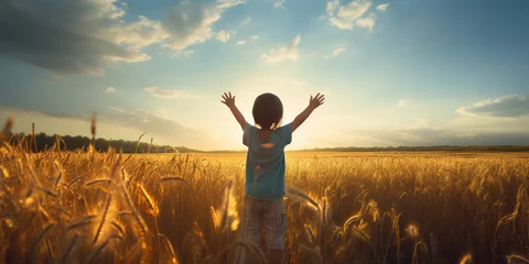 Foto op Canvas Child with arms uplifted, standing in an open field © Malika