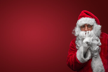 Santa Claus gesturing silence with finger on lips, mysterious holiday secret concept