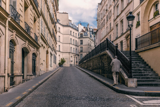 An Old Gentleman Walking On A Neighborhood In Montparnasse In Paris