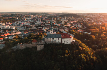 Nitra Castle and streets of Nitra city on sunset - autumn time. Aerial view of beautiful and fairytale Nitra Castle.