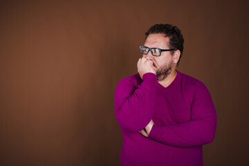 Funny fat man posing in studio on brown background. Different emotions.