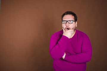 Funny fat man posing in studio on brown background. Different emotions.