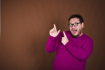 Funny fat man posing in studio on brown background. Different emotions.