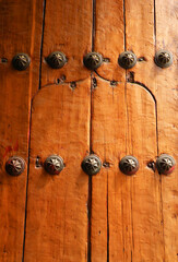 Old wooden door with iron rivets