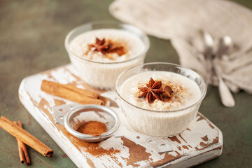 Spanish rice pudding Arroz con Leche in glass cream bowl on the table