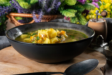 Cucumber soup in dark bowl.