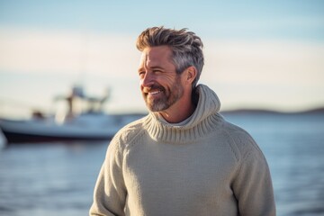 Fototapeta premium Portrait of a happy man in his 40s dressed in a warm wool sweater against a pastel blue background. AI Generation