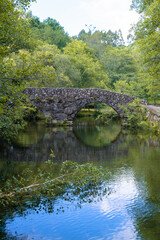 Fototapeta na wymiar Beautiful view of a stone bridge on the Maceira river beach. Covelo - Galicia - Spain