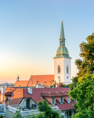 Bratislava cathedral of St. Martin at sunrise with old town tiled roofs