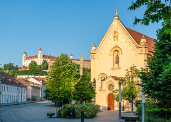 Bratislava castle and Capuchin church with copy space on blue sky