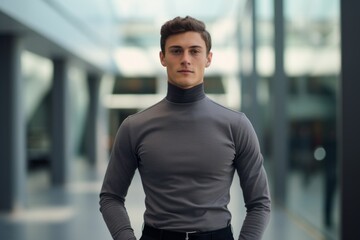 Portrait of a merry man in his 20s showing off a lightweight base layer against a sophisticated corporate office background. AI Generation