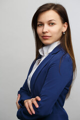 Business woman in a suit  isolated on grey background.