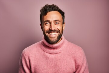 Fototapeta premium Portrait of a happy man in his 30s dressed in a warm wool sweater against a pastel or soft colors background. AI Generation