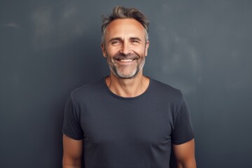 Portrait of a smiling man in his 40s sporting a vintage band t-shirt against a minimalist or empty room background. AI Generation