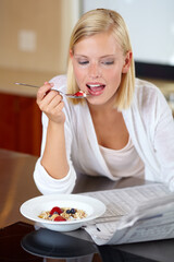 Woman, eating breakfast and reading newspaper to relax, peace and newsletter at home. Female...