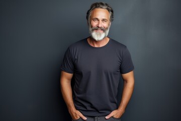 Portrait of a blissful man in his 50s sporting a vintage band t-shirt against a minimalist or empty...