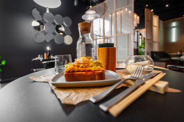 Croque Madame hot french sandwich with ham, melted cheese, fried egg and sauce.