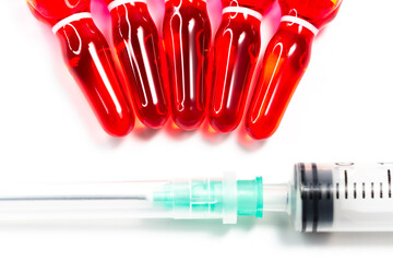B12 hormone injection ampoules in selective focus. Ampoules and syringes containing solution for...