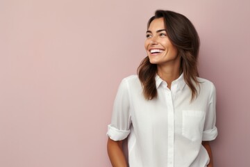 Fototapeta premium Portrait of a satisfied woman in her 30s wearing a simple cotton shirt against a solid pastel color wall. AI Generation