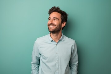 Fototapeta premium Portrait of a cheerful man in his 30s donning a classy polo shirt against a solid pastel color wall. AI Generation