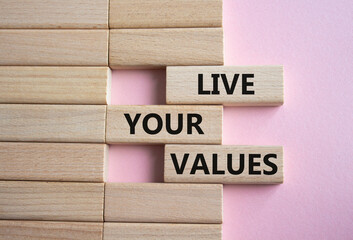 Live your values symbol. Concept words Live your values on wooden blocks. Beautiful pink...