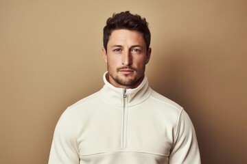 Obraz premium Portrait of a glad man in his 30s wearing a thermal fleece pullover against a light wood minimalistic setup. AI Generation