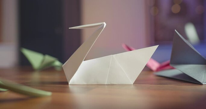 Origami paper swan on table - close up