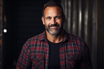 Fototapeta premium Portrait of a joyful man in his 40s wearing a comfy flannel shirt against a empty modern loft background. AI Generation