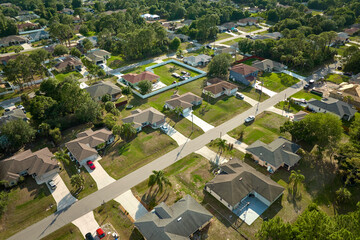 Aerial landscape view of suburban private houses between green palm trees in Florida quiet rural...