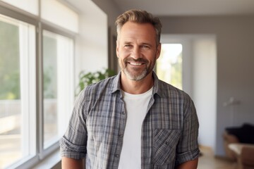 Obraz premium Portrait of a satisfied man in his 40s dressed in a relaxed flannel shirt against a crisp minimalistic living room. AI Generation