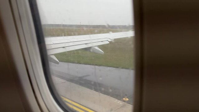 View from airplane taxiing in Modlin airport in Poland in November on rainy day