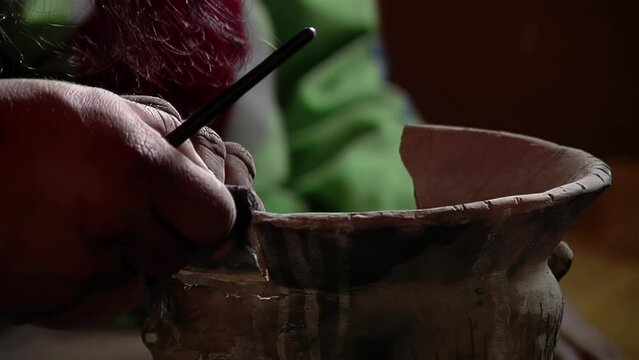 Archaeologist Putting Broken Pottery Pieces Back Together. Close Up.