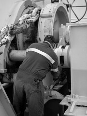 grasing forward winch on board a ship , black and white photo
