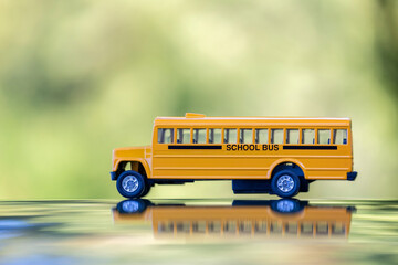 Small model of american yellow school bus as symbol of education in the USA