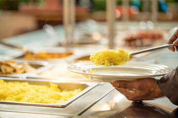 Asian food buffet in restaurant multiple food dishes and salad.