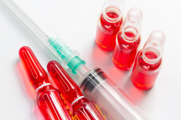 B12 hormone injection ampoules in selective focus. Ampoules and syringes containing solution for...
