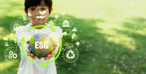 Focused planet Earth globe with eco friendly icon hold by blur little boy, symbolize environmental...