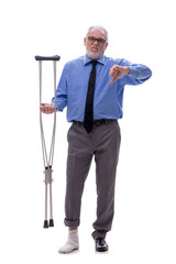 Old businessman with crutches isolated on white