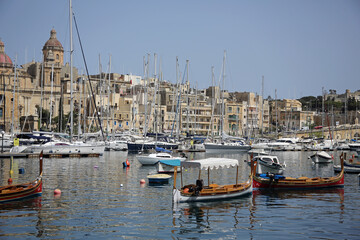 Yachts and old buildings in Valletta , Malta