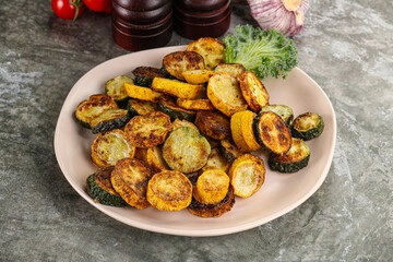 Roasted young zucchini in the plate