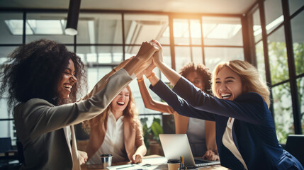 Moment of celebration, with a group of women in a business setting giving each other a high five, all smiling and exuding happiness and a sense of achievement. - Powered by Adobe