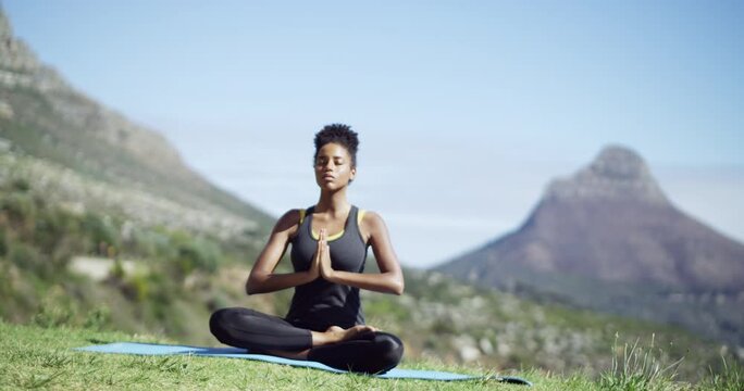 Yoga, meditation and woman on mountain for calm, peace and mindfulness on exercise mat outdoors. Nature, pilates and person praying for meditating, spiritual mindset and zen wellness in summer