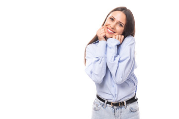 Fototapeta premium young charming european business woman with long black hair dressed in a blue blouse on a white background with copy space