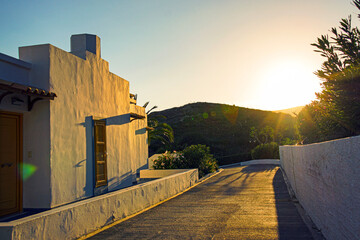 impressive sunset over hills with typical white greek houses in the foreground - obrazy, fototapety, plakaty