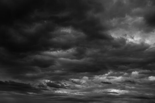 Storm sky with dark grey  black clouds  abstract background texture, thunderstorm. Black and white photo