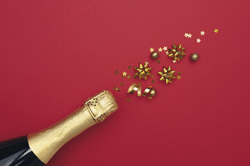 Champagne bottle with confetti stars on color background, space for text