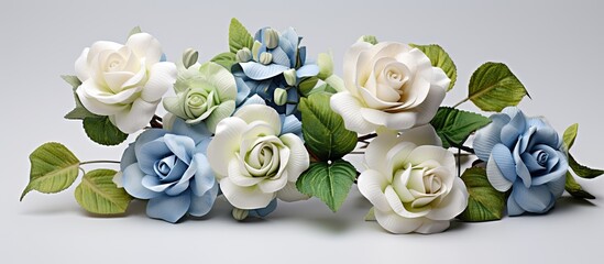 Obraz na płótnie Canvas The exquisite floral design of white, green, and blue roses creates a romantic atmosphere for a spring wedding, as the isolated white background brings attention to the table adorned with delicate